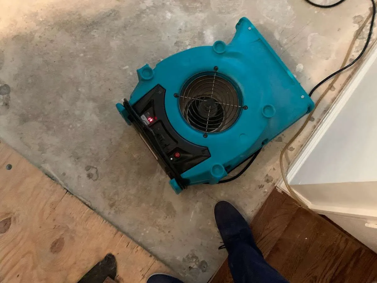 Air mover drying subfloor during Commercial Water Damage Restoration in Ellensburg